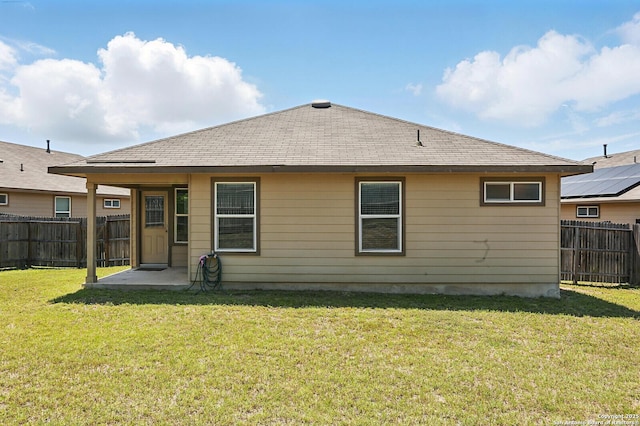back of property featuring a patio and roof with shingles