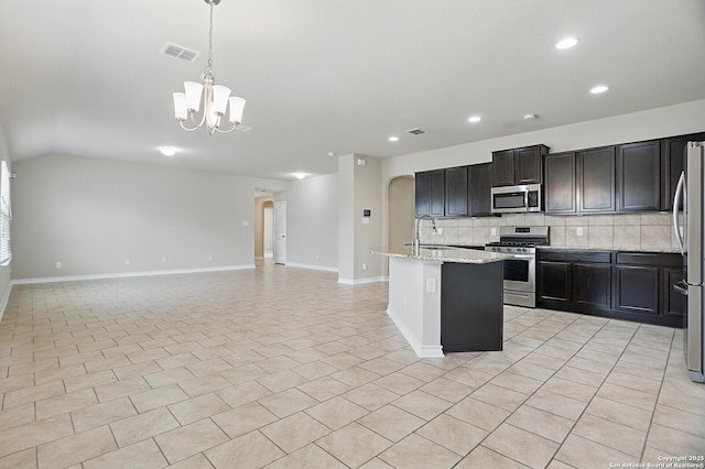 kitchen with stainless steel appliances, a chandelier, backsplash, recessed lighting, and a sink