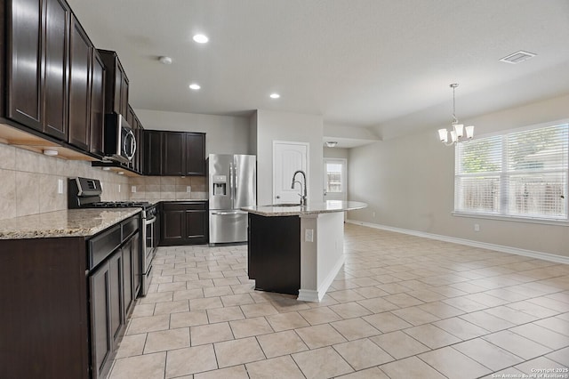 kitchen featuring stainless steel appliances, healthy amount of natural light, a chandelier, decorative backsplash, and recessed lighting
