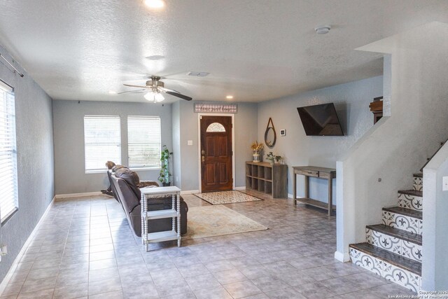 5311 Moreville Farm, San Antonio, TX 78228 - foyer entrance with a ceiling fan, a textured ceiling, stairway, and baseboards