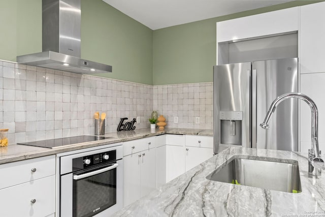 1115 S Alamo St Unit 2211, San Antonio, TX 78210 - kitchen featuring wall oven, wall chimney range hood, a sink, black electric stovetop, and stainless steel fridge