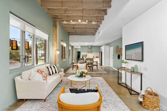 1115 S Alamo St Unit 2211, San Antonio, TX 78210 - living room with a towering ceiling, finished concrete flooring, and baseboards
