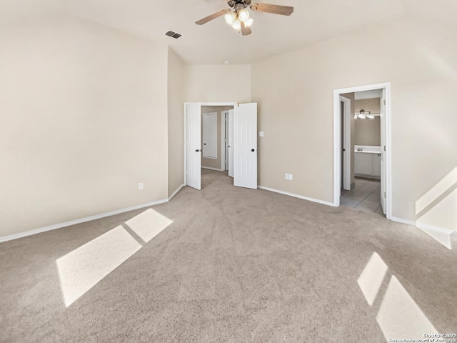 121 Lark Hl, Floresville, TX 78114 - unfurnished bedroom with carpet flooring, baseboards, ensuite bathroom, and a ceiling fan