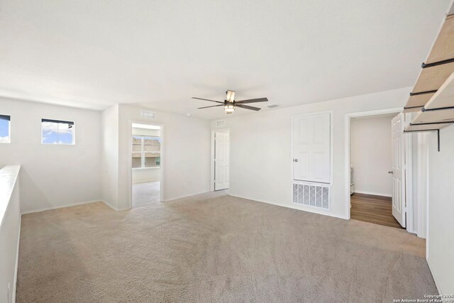 6322 Silver Pegasus, San Antonio, TX 78218 - unfurnished living room with carpet floors, ceiling fan, and baseboards