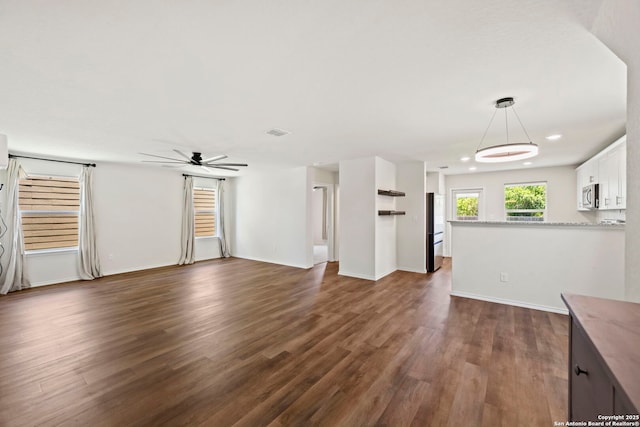 6322 Silver Pegasus, San Antonio, TX 78218 - unfurnished living room featuring ceiling fan, dark wood finished floors, recessed lighting, and baseboards