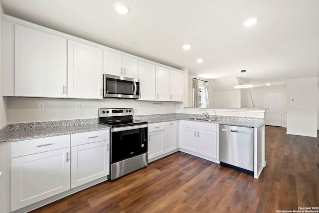 6322 Silver Pegasus, San Antonio, TX 78218 - kitchen featuring stainless steel appliances, a sink, a peninsula, white cabinets, and recessed lighting