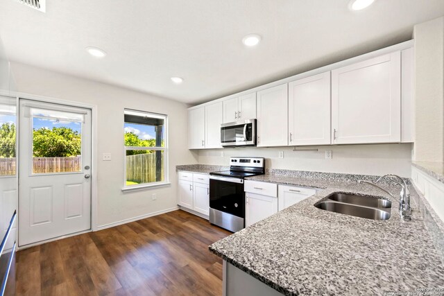 6322 Silver Pegasus, San Antonio, TX 78218 - kitchen featuring appliances with stainless steel finishes, a sink, light stone countertops, white cabinets, and recessed lighting
