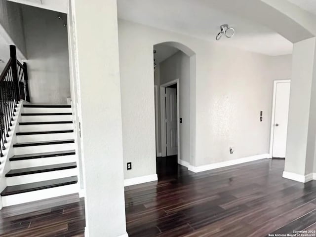 1115 Caspian, San Antonio, TX 78245 - staircase with wood finished floors, arched walkways, and baseboards