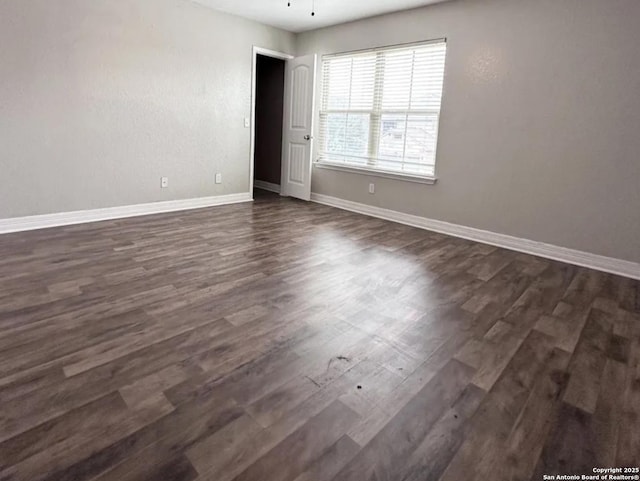 1115 Caspian, San Antonio, TX 78245 - spare room with dark wood-type flooring and baseboards