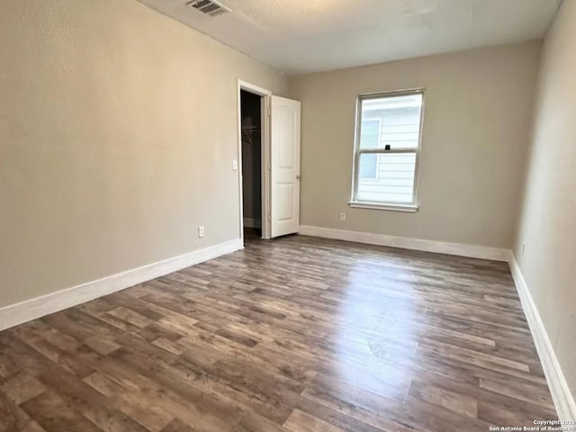 1115 Caspian, San Antonio, TX 78245 - unfurnished bedroom featuring dark wood finished floors and baseboards