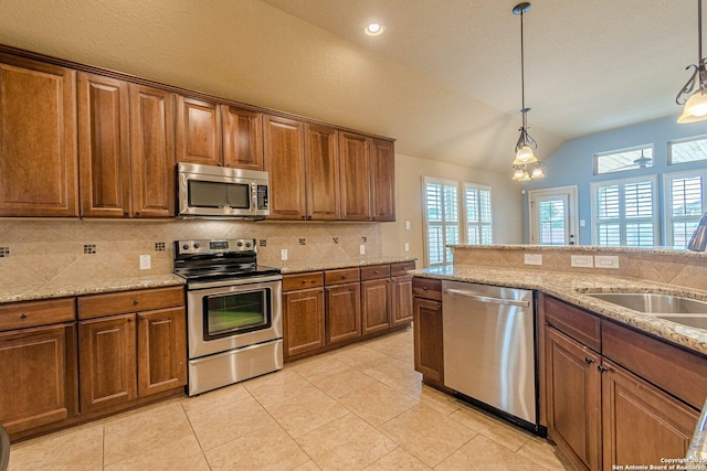 15522 Echo, Selma, TX 78154 - kitchen with stainless steel appliances, lofted ceiling, tasteful backsplash, decorative light fixtures, and a sink
