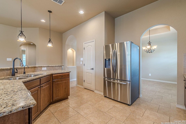 15522 Echo, Selma, TX 78154 - kitchen featuring stainless steel fridge, a sink, arched walkways, recessed lighting, and a chandelier