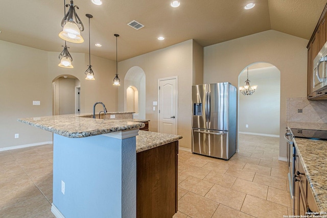 15522 Echo, Selma, TX 78154 - kitchen with appliances with stainless steel finishes, arched walkways, an island with sink, light tile patterned flooring, and lofted ceiling