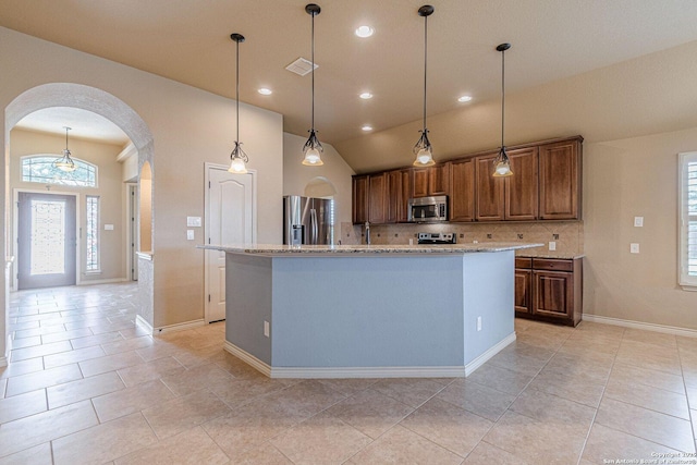 15522 Echo, Selma, TX 78154 - kitchen featuring stainless steel appliances, arched walkways, backsplash, healthy amount of natural light, and lofted ceiling