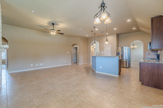 15522 Echo, Selma, TX 78154 - kitchen featuring arched walkways, stainless steel appliances, a chandelier, ceiling fan, and light stone counters
