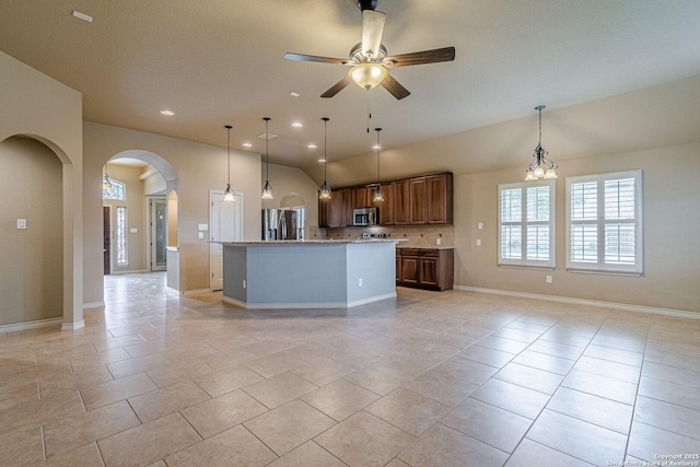 15522 Echo, Selma, TX 78154 - kitchen featuring appliances with stainless steel finishes, arched walkways, open floor plan, a ceiling fan, and lofted ceiling