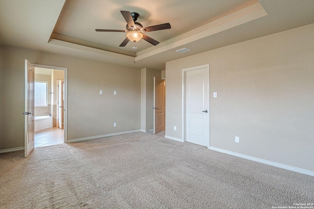 15522 Echo, Selma, TX 78154 - unfurnished bedroom featuring a raised ceiling, light carpet, baseboards, and ensuite bath