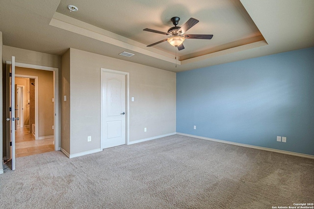 15522 Echo, Selma, TX 78154 - unfurnished bedroom with a tray ceiling, carpet floors, baseboards, and ceiling fan