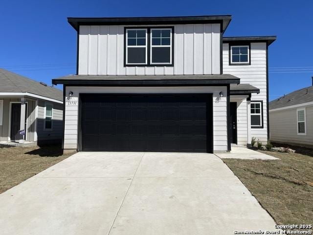 13731 Redtail Lndg, San Antonio, TX 78253 - view of front of house with board and batten siding, an attached garage, and concrete driveway