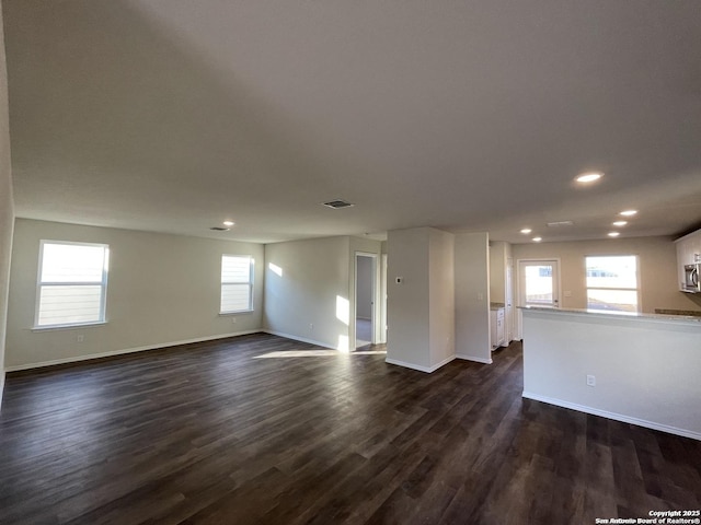 13731 Redtail Lndg, San Antonio, TX 78253 - unfurnished living room featuring recessed lighting, baseboards, and dark wood-type flooring
