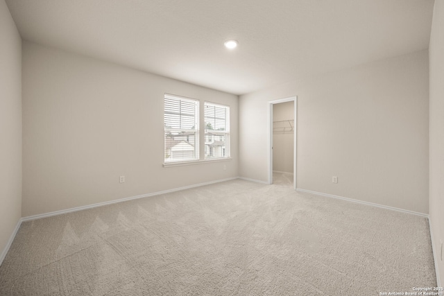 13731 Redtail Lndg, San Antonio, TX 78253 - unfurnished bedroom with baseboards, carpet flooring, a walk in closet, recessed lighting, and a closet