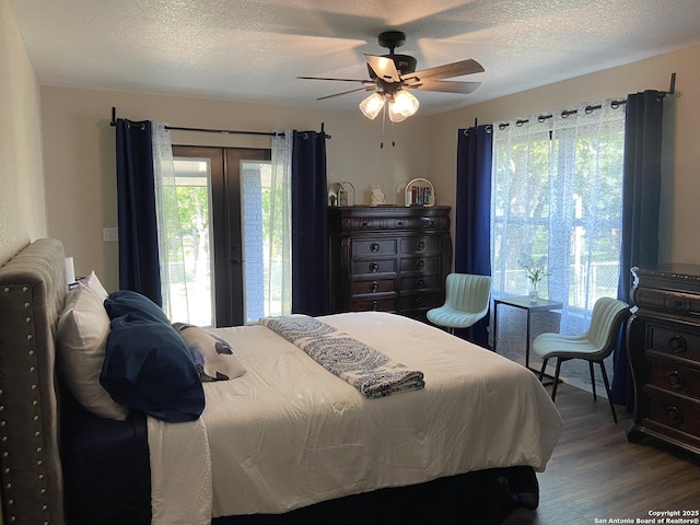 326 Riverview, Mcqueeney, TX 78123 - bedroom featuring access to outside, wood finished floors, ceiling fan, and a textured ceiling