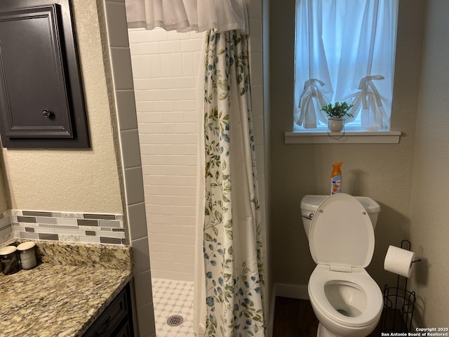 326 Riverview, Mcqueeney, TX 78123 - bathroom with a stall shower, toilet, and decorative backsplash