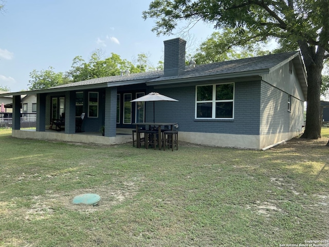 326 Riverview, Mcqueeney, TX 78123 - rear view of property featuring a chimney, a yard, brick siding, and a shingled roof