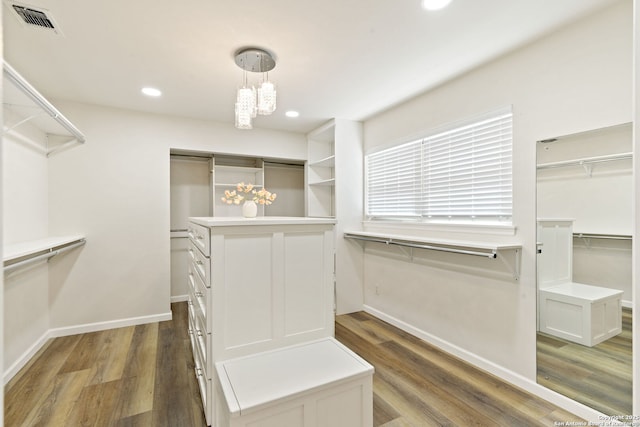 430 Yosemite Dr, San Antonio, TX 78232 - walk in closet featuring wood finished floors and a chandelier