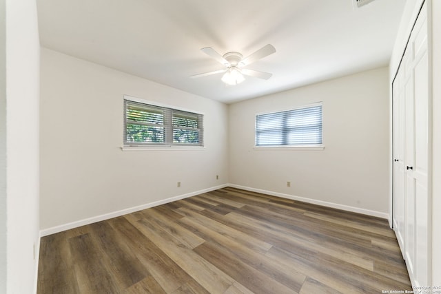 430 Yosemite Dr, San Antonio, TX 78232 - unfurnished bedroom featuring multiple windows, wood finished floors, baseboards, and a closet