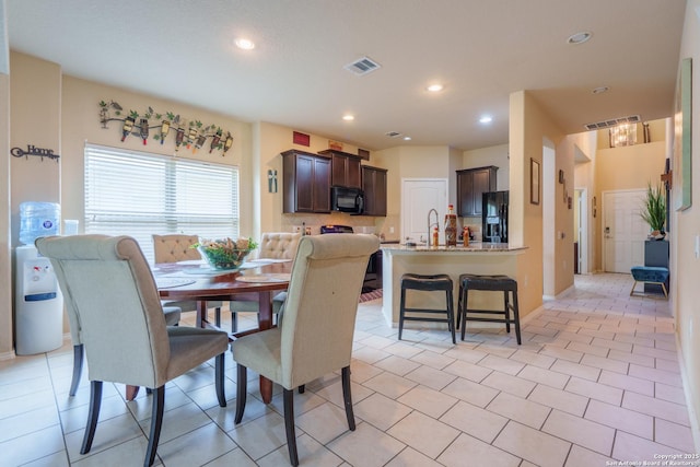 11607 Pelican Pass, San Antonio, TX 78221 - dining room with recessed lighting, light tile patterned floors, and baseboards