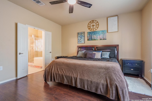 11607 Pelican Pass, San Antonio, TX 78221 - bedroom with wood finished floors, ensuite bathroom, and baseboards