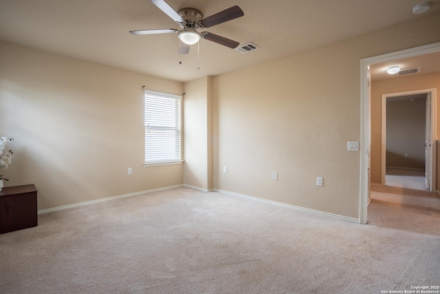 11607 Pelican Pass, San Antonio, TX 78221 - empty room with a smoke detector, light colored carpet, ceiling fan, and baseboards
