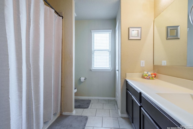 11607 Pelican Pass, San Antonio, TX 78221 - bathroom with vanity, tile patterned floors, and baseboards