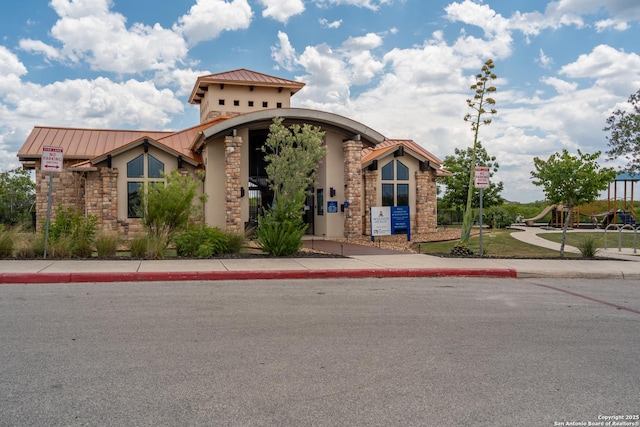 11607 Pelican Pass, San Antonio, TX 78221 - view of front of home featuring a standing seam roof, stucco siding, and stone siding