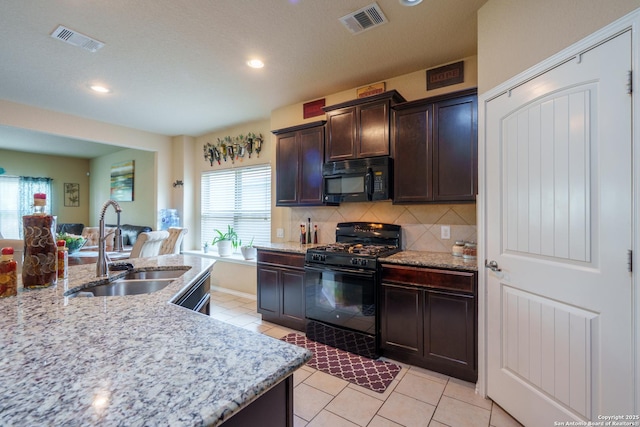 11607 Pelican Pass, San Antonio, TX 78221 - kitchen with black appliances, a sink, tasteful backsplash, dark brown cabinets, and light tile patterned flooring