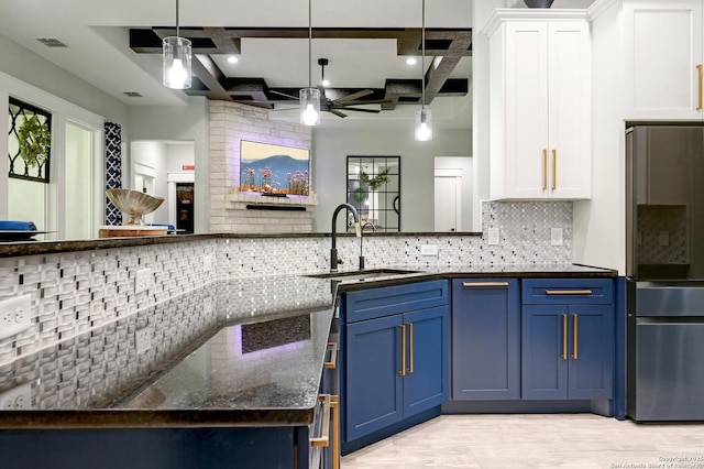 149 Chisum Ln, Vernia, TX 78121 - kitchen with ceiling fan, coffered ceiling, a sink, blue cabinets, and freestanding refrigerator