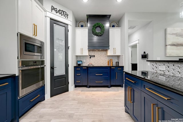 149 Chisum Ln, Vernia, TX 78121 - kitchen featuring stainless steel appliances, white cabinetry, blue cabinetry, decorative backsplash, and recessed lighting