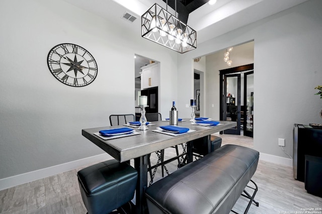149 Chisum Ln, Vernia, TX 78121 - dining area featuring baseboards, light wood-style flooring, and a chandelier