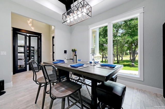 149 Chisum Ln, Vernia, TX 78121 - dining area featuring baseboards, a chandelier, and light wood-style flooring