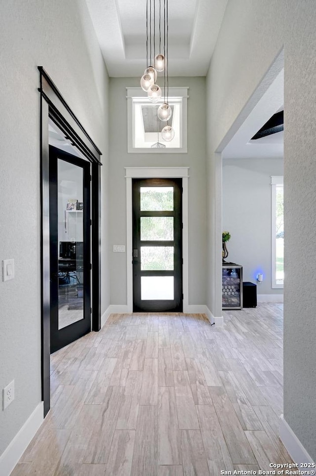 149 Chisum Ln, Vernia, TX 78121 - foyer featuring wood finished floors, plenty of natural light, a towering ceiling, and baseboards