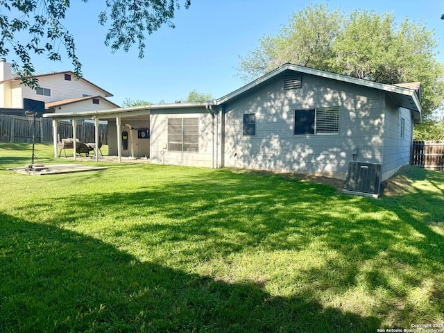 1303 Billings Dr, San Antonio, TX 78245 - back of property with a patio area and central AC