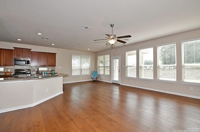 14402 Palomino Pl, San Antonio, TX 78254 - kitchen featuring appliances with stainless steel finishes, baseboards, ceiling fan, dark wood-style flooring, and backsplash