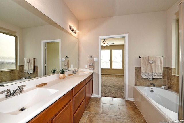 14402 Palomino Pl, San Antonio, TX 78254 - full bathroom featuring double vanity, a garden tub, ceiling fan, and baseboards