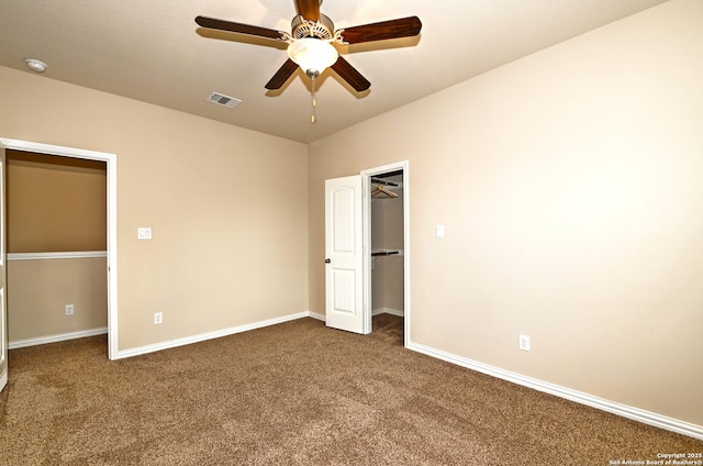 14402 Palomino Pl, San Antonio, TX 78254 - unfurnished bedroom with dark carpet, a spacious closet, baseboards, and a closet