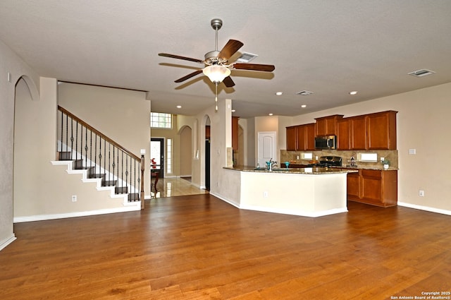 14402 Palomino Pl, San Antonio, TX 78254 - kitchen featuring stainless steel appliances, wood finished floors, a ceiling fan, arched walkways, and recessed lighting