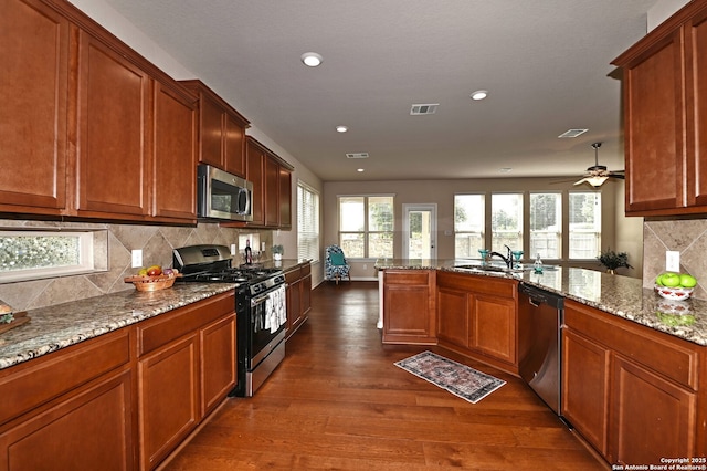14402 Palomino Pl, San Antonio, TX 78254 - kitchen featuring stainless steel appliances, dark wood-style floors, a sink, healthy amount of natural light, and recessed lighting
