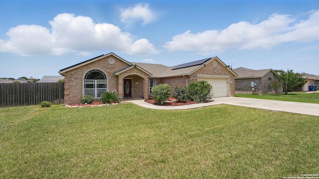 1070 Northpark, New Braunfels, TX 78130 - ranch-style home with brick siding, solar panels, driveway, and a garage