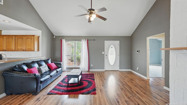 1070 Northpark, New Braunfels, TX 78130 - living room with ceiling fan, light wood-style floors, high vaulted ceiling, and baseboards