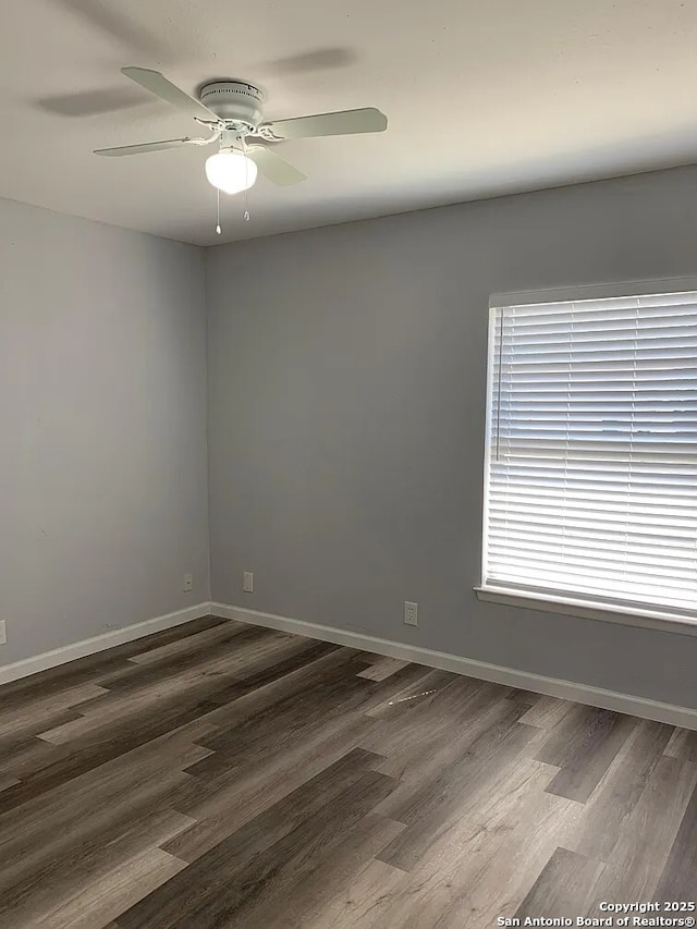 5135 Tom Stafford, Kirby, TX 78219 - empty room with dark wood-type flooring, ceiling fan, and baseboards